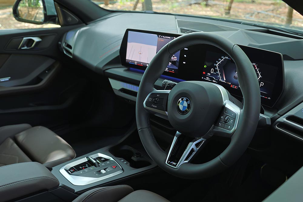 The cabin uses sustainable Veganza upholstery in Mocha or Oyster shades, paired with a 205-watt Harman Kardon sound system.