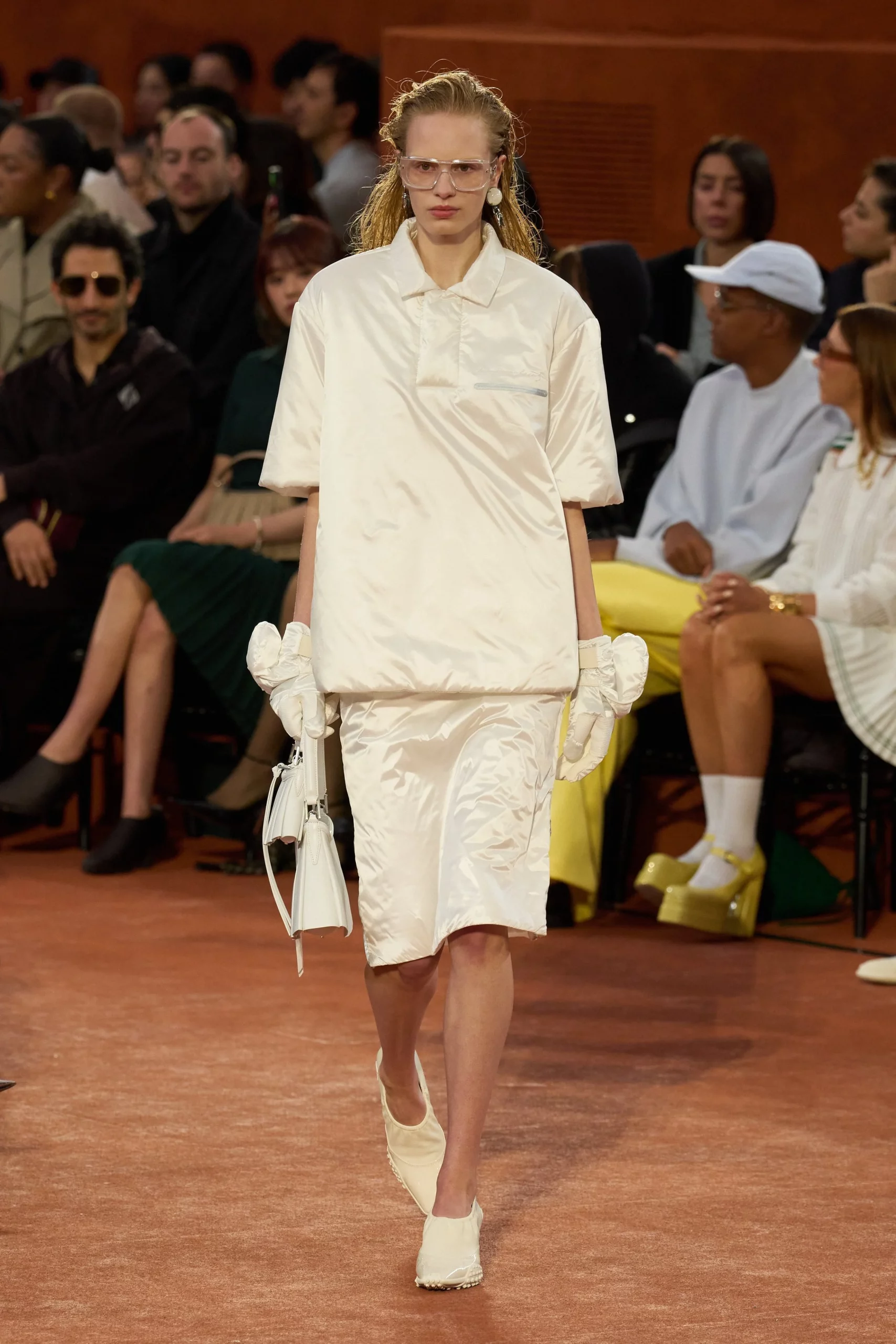 Lacoste’s heritage polo takes centre stage, bridging its century-old tennis legacy with modern runway relevance.