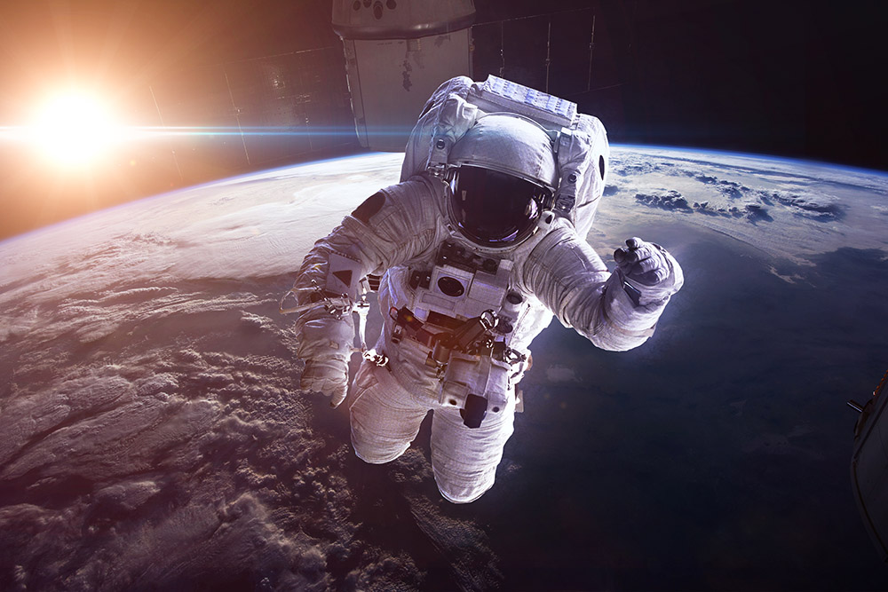 Astronaut in outer space against the backdrop of the planet earth. Elements of this image furnished by NASA
