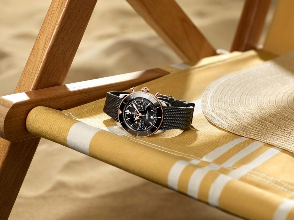 This 42mm variant that gets an 18k red gold case, an onion crown at 3 o’clock, and an anodized ceramic inlayed bezel with a glossy black ceramic insert with an inverted triangle at 12 o’clock