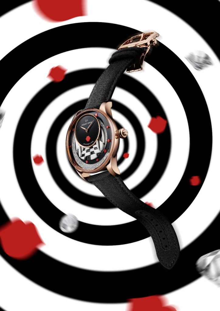 Crafted with an exquisite fusion of rare materials and mechanical artistry, this timepiece features a hand-painted black onyx dial framed by an 18k red gold applied ring and housed within a matching 18-karat red gold case