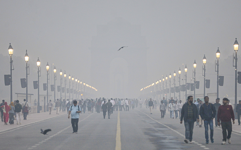 Air pollution in Delhi,Smog engulfs Kartavya Path as people take a stroll amid low visibility, near the India Gate in New Delhi