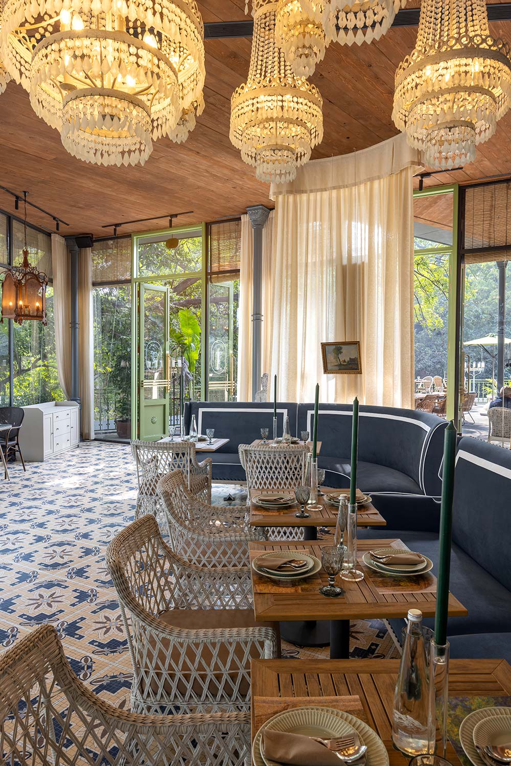 Vintage pieces like pianolas, chandeliers, cabinets, and patinated railings adorn the interiors