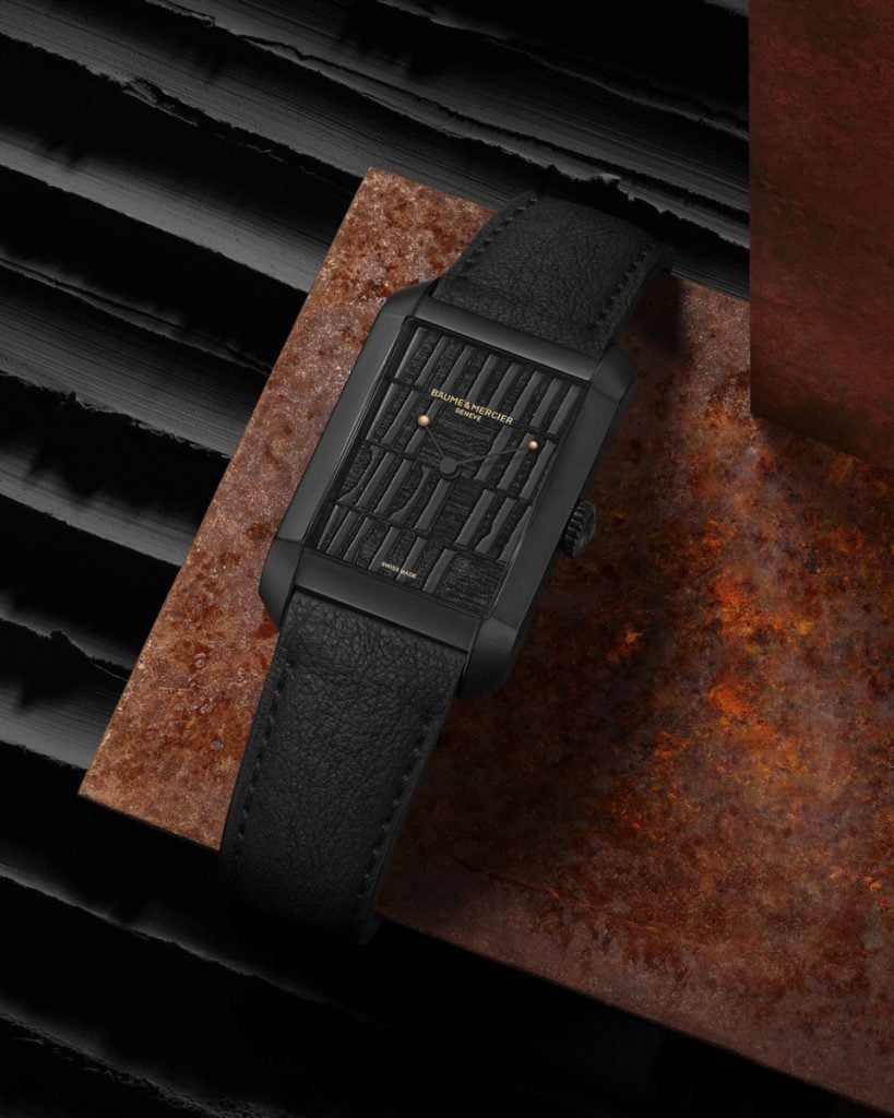 The 48mm watch has a black, opaline rectangular dial with shades of textured black that change depending on the light source