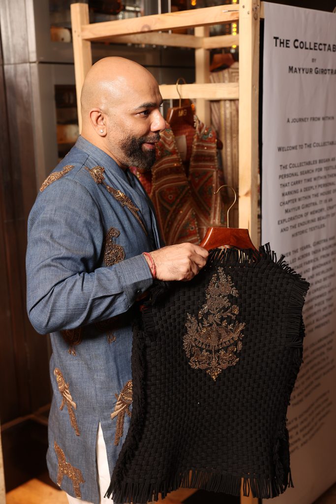 Mayyur Girotra holding a jacket from The Collectible collection , Indian textiles, Indian heritage craftsman, Indian handloom, Indian embroidery, Mayyur Girotra embroidery, Mayyur Girotra boutique, Mayyur Girotra traditional, 