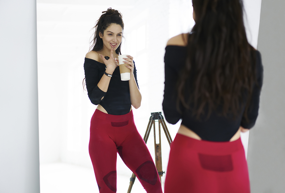 Smiling attractive female athletic dressed in trendy sports clothes