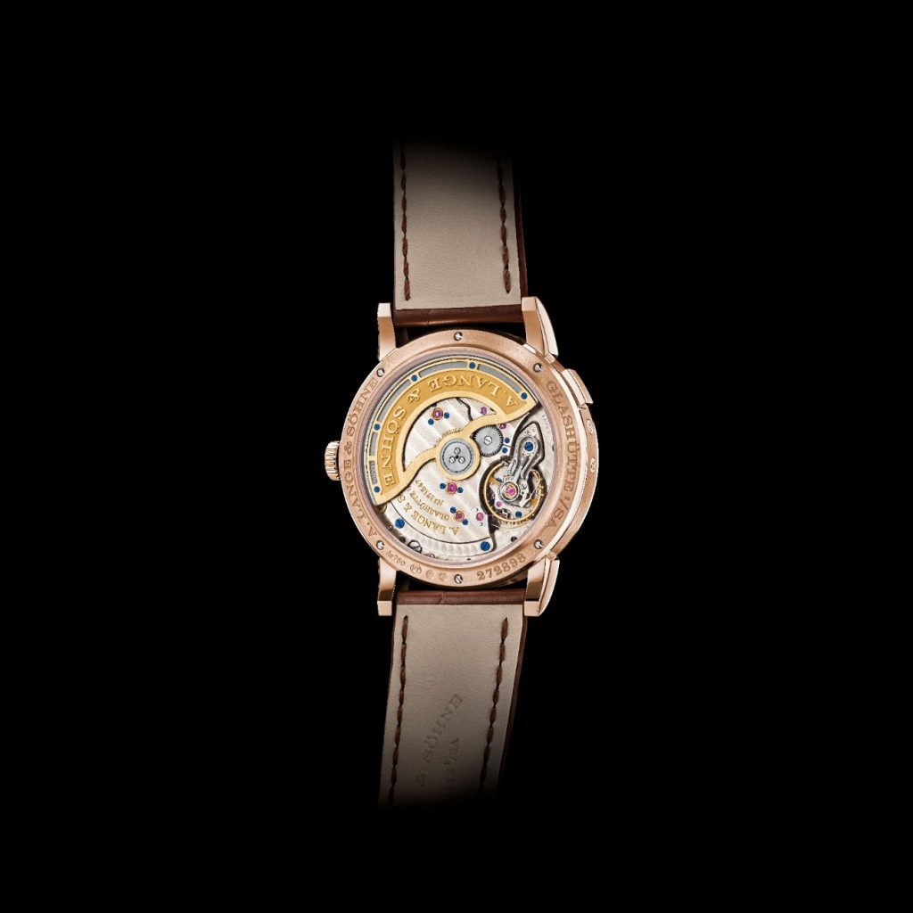 The layout is elegantly balanced, with the day of the week displayed on a sub dial at 9 o’clock