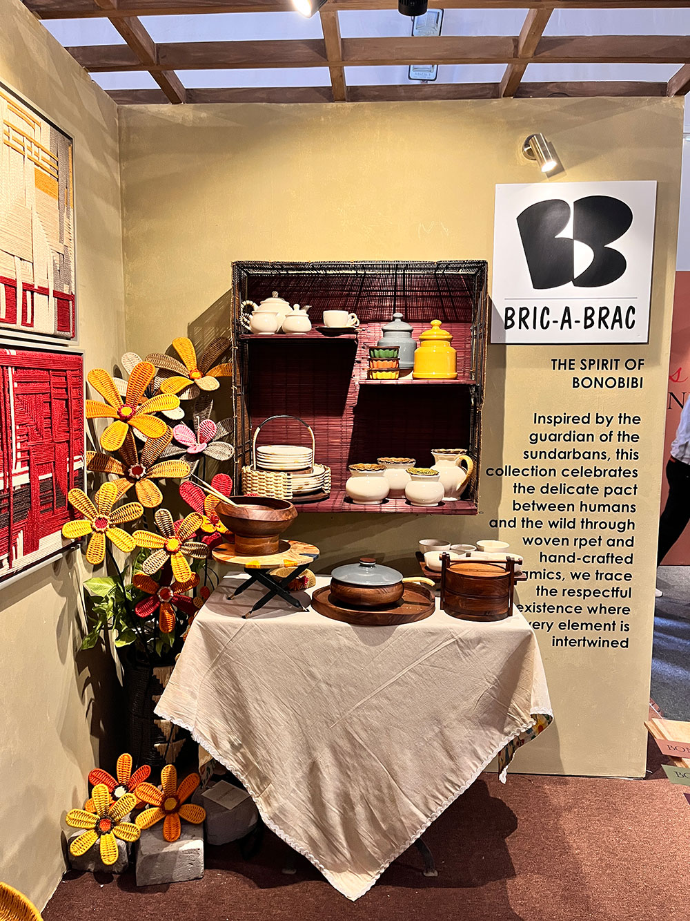 Bric A Brac, almost resurrected, the revered guardians, spirit, and folk goddess of the Sundarbans forest, Bonobibi. It celebrates the delicate part between humans and the wild through recycled yarn wall hangings and flora shops, along with serveware decked on a styled kitchen-like set-up.