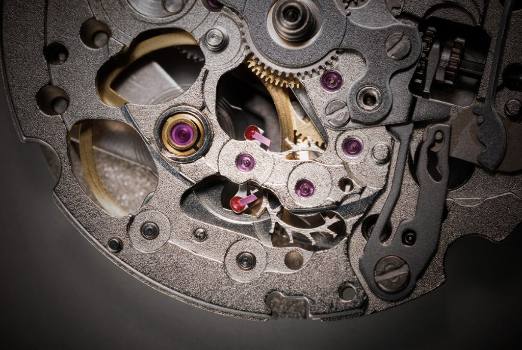 Imagine a tiny metal anchor with two jewel-tipped arms and a forked end.