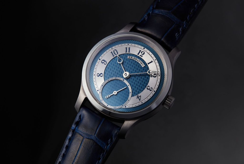 The watch is housed in a 39 mm tantalum case, combining brushed and polished finishes that highlight