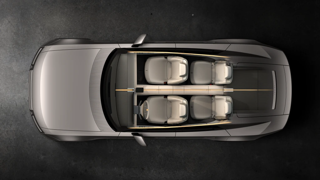 Inside, a central spine runs the cabin’s full length, dividing the interior into four distinct spaces, each framed