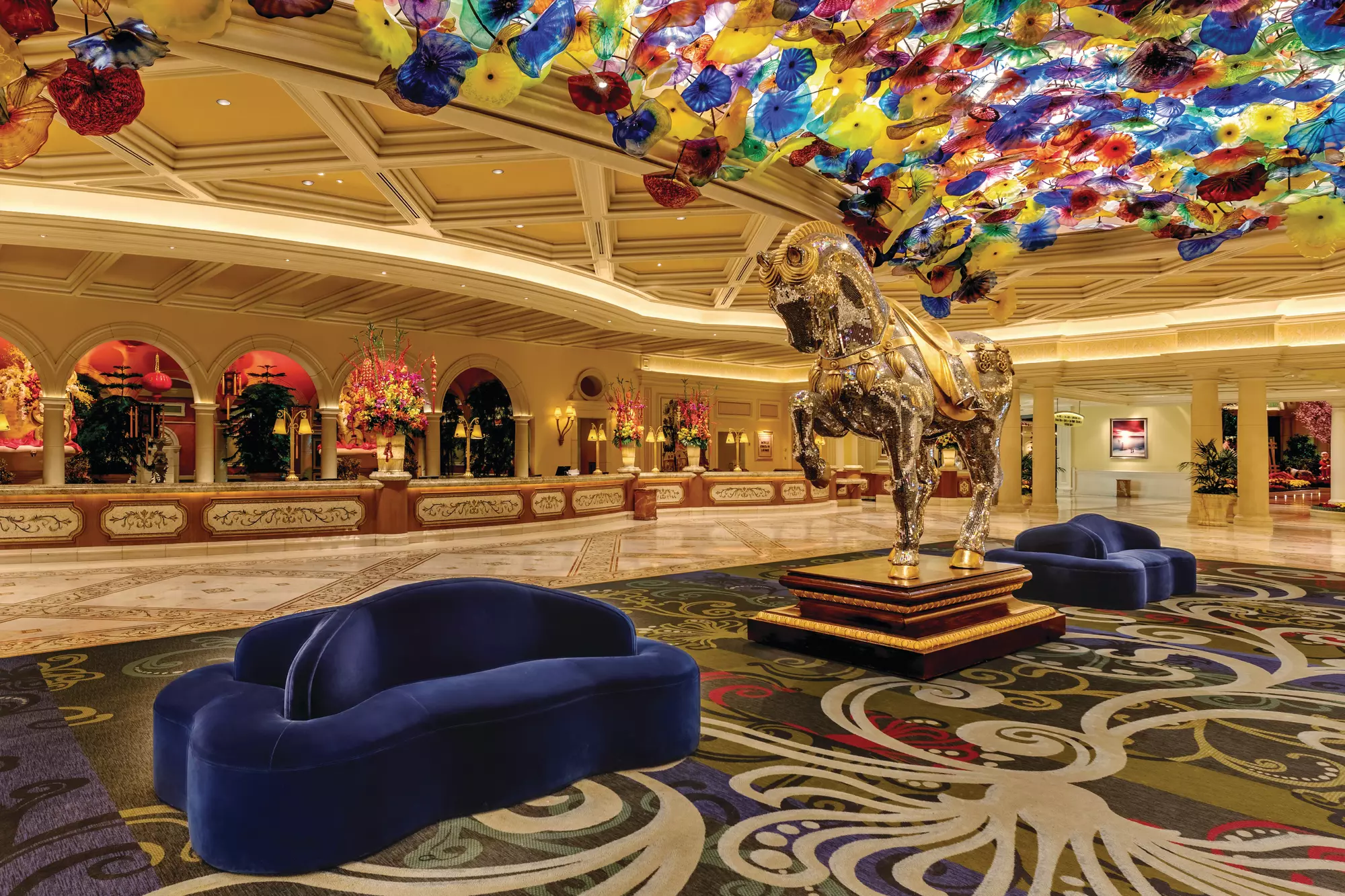 At Bellagio, the ceiling is the star. Overhead floats Dale Chihuly’s Fiori di Como, a vast sculpture composed